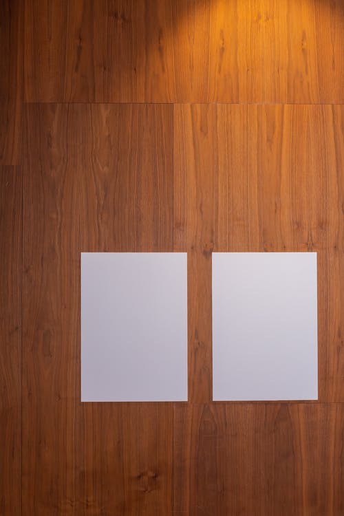 棕色木地板上的白色打印机纸 · 免费素材图片