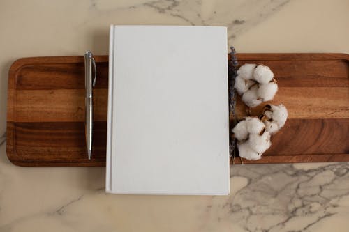 棕色木制的桌子上的白皮书 · 免费素材图片