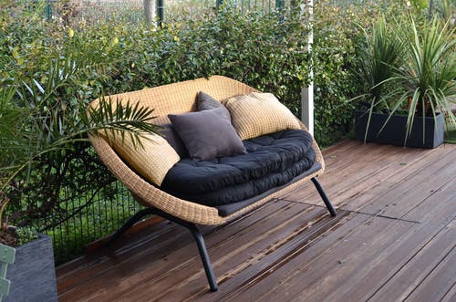 黑色和棕色扶手椅，棕色木地板上 · 免费素材图片