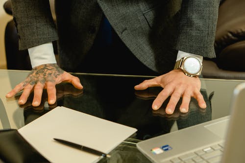 黑色西装外套的人穿着银色圆形模拟手表 · 免费素材图片