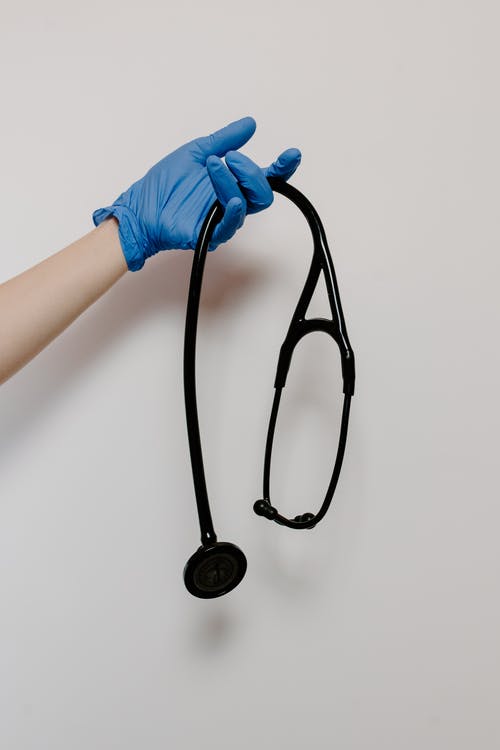 有关垂直拍摄, 手术手套, 握住的免费素材图片