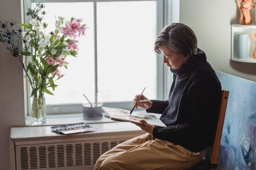 一个女人在画板中绘画作品 · 免费素材图片