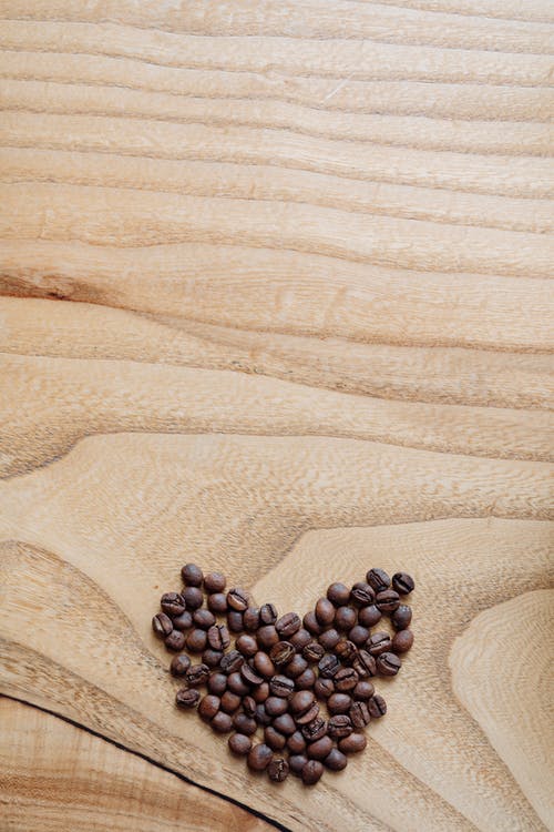 有关咖啡豆, 垂直拍摄, 木制表面的免费素材图片