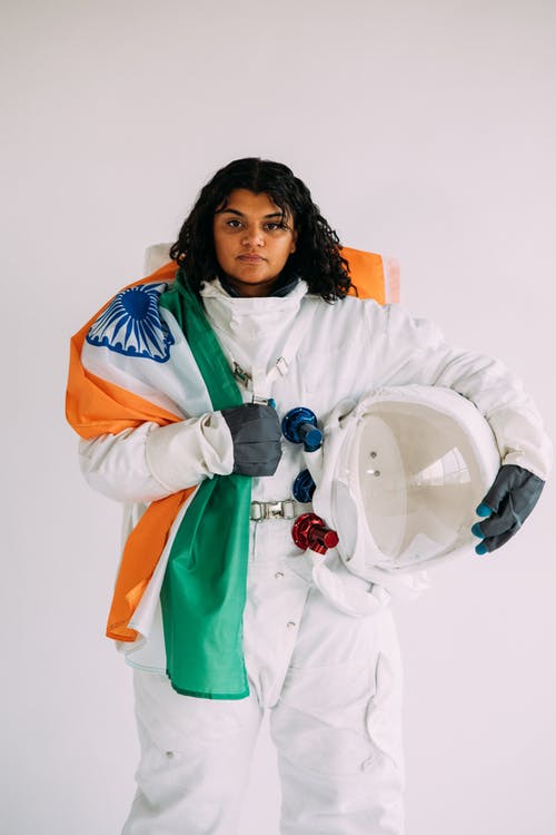 拿着旗子的宇航员服装的女人 · 免费素材图片