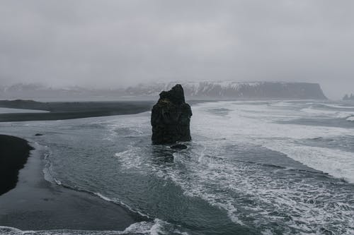 海水在白云下的黑岩形成 · 免费素材图片