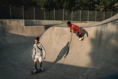 多种族的运动员在滑板公园的坡道上滑板 · 免费素材图片