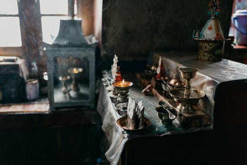 传统的佛教碗和蜡烛在教堂里 · 免费素材图片