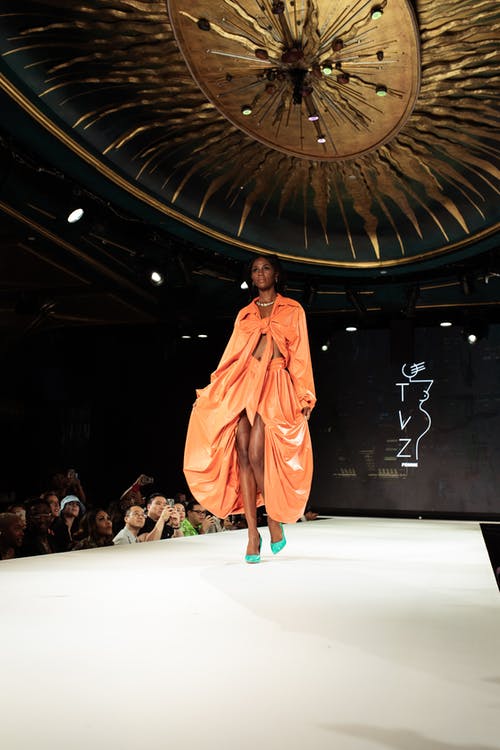 站在舞台上的橙色长袍的女人 · 免费素材图片