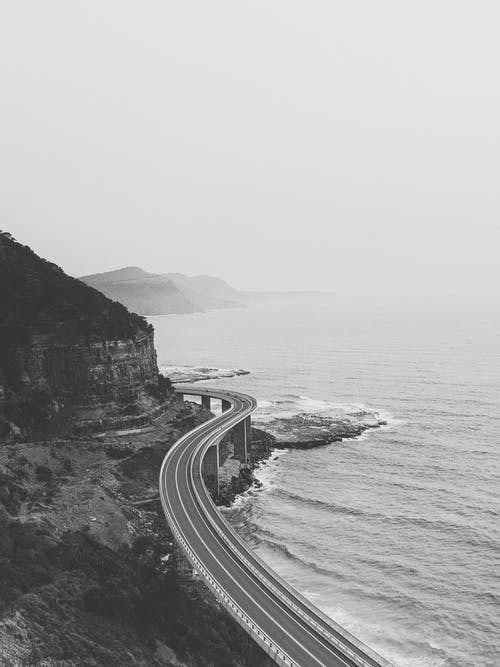 海滨公路的灰度照片 · 免费素材图片