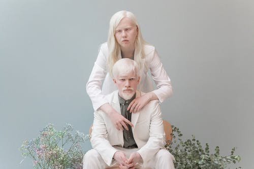有魅力的白化夫妇拥抱灰色背景 · 免费素材图片