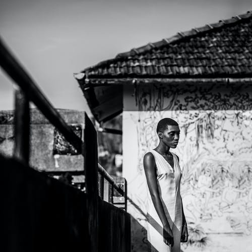 女人站在扶手旁边的单色照片 · 免费素材图片