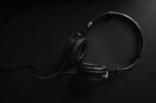 黑色表面上的黑色和银色耳机 · 免费素材图片