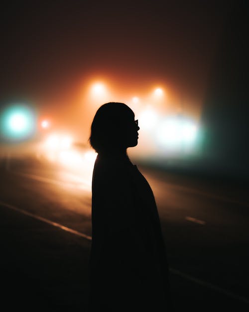 夜间站在路上的人的身影 · 免费素材图片