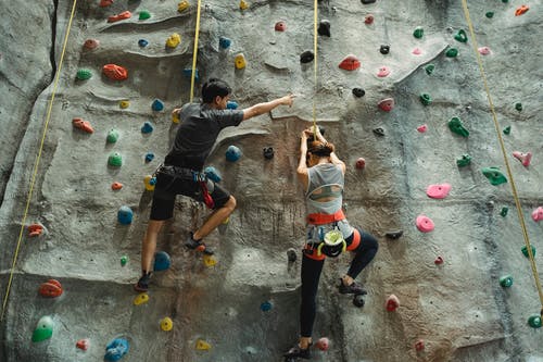 无法认出的登山者在健身房的墙上练习 · 免费素材图片