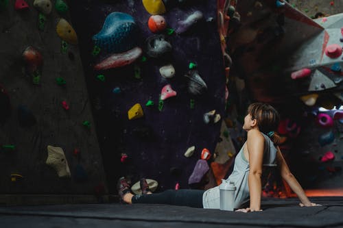 女人在运动垫在攀岩中心休息 · 免费素材图片