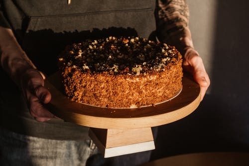 人控股，美味的圆形蛋糕 · 免费素材图片
