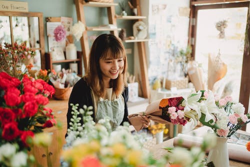 在舒适的花店工作的快乐亚洲花店 · 免费素材图片