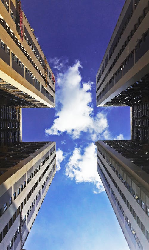 多云的天空的摩天大楼的低角度视图 · 免费素材图片