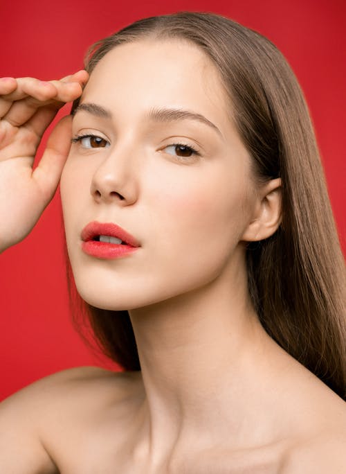 红色的唇膏和红色背景的女人 · 免费素材图片
