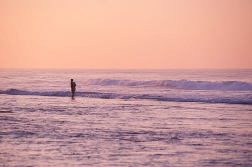 黄金时段站在海边的人 · 免费素材图片