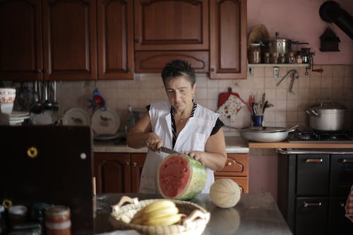 切片西瓜的女人 · 免费素材图片
