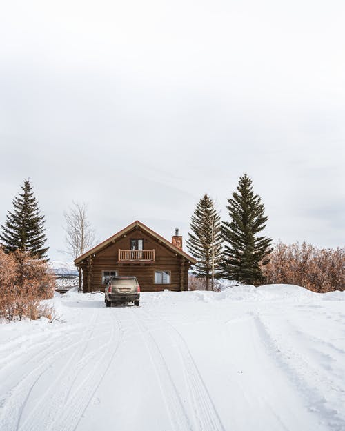 积雪的地面上的棕色木屋 · 免费素材图片