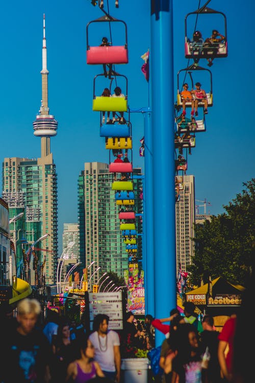 一群人站在白天的邮政和灰色大楼附近 · 免费素材图片