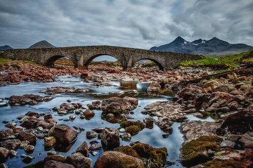 岩石水体，白天有混凝土桥的景色 · 免费素材图片