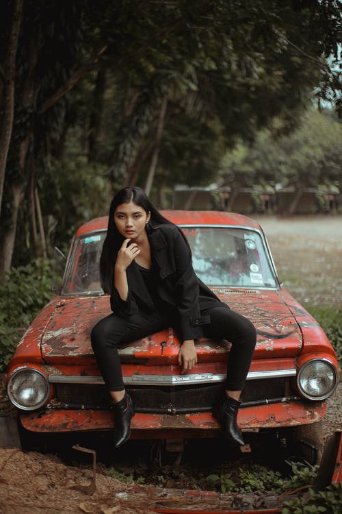黑色衣服坐在红色的车上的女人 · 免费素材图片