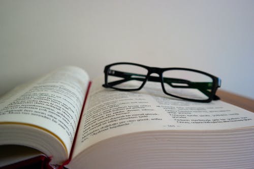 眼镜在书上的特写镜头 · 免费素材图片