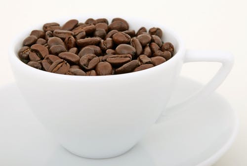 白色陶瓷杯上的咖啡豆 · 免费素材图片