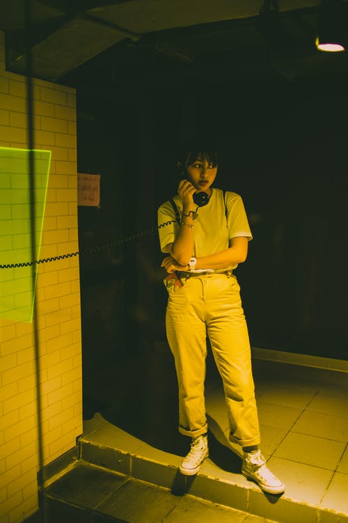 使用公用电话的女性站立照片 · 免费素材图片