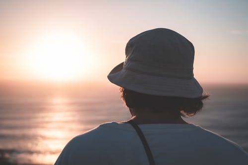 匿名男子在荡漾的大海享受日落 · 免费素材图片