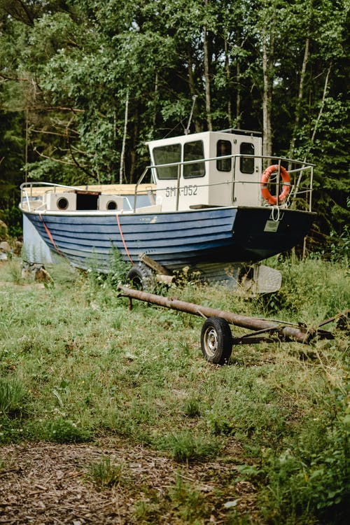 白色和蓝色的小船，在绿色的草地上 · 免费素材图片