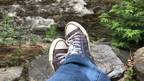 一个人的脚，搁在一块岩石上 · 免费素材视频