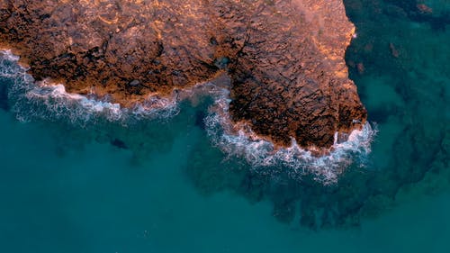 海浪在岸边的岩石上崩溃 · 免费素材视频