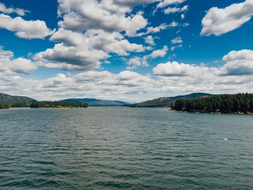 时间流逝的镜头，美丽的风景包围的湖上空的云 · 免费素材视频