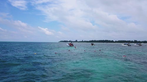人们喜欢在海中船附近游泳的航拍 · 免费素材视频