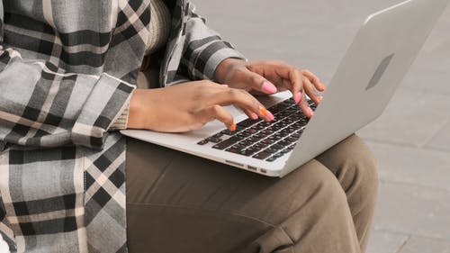 一个女人坐在长凳上户外她的笔记本电脑上工作 · 免费素材视频