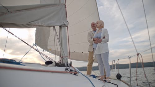 一对老年夫妇站在一艘游艇上充满爱意的拥抱 · 免费素材视频