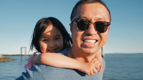 戴墨镜的爸爸抱着他可爱的女儿 · 免费素材视频