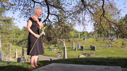 一位在墓地悲伤的老妇人 · 免费素材视频