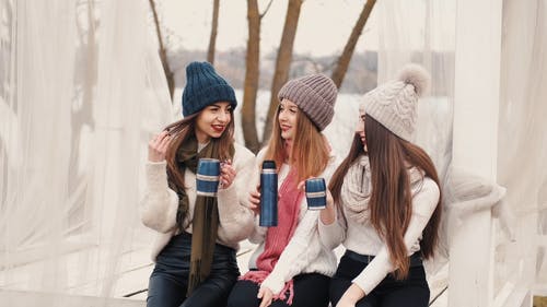 有关（顶部有小羊毛球的）羊毛帽子, 交叉的双腿, 坐的免费素材视频