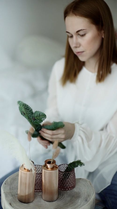 一个女人把圣诞节花环打破成碎片 · 免费素材视频