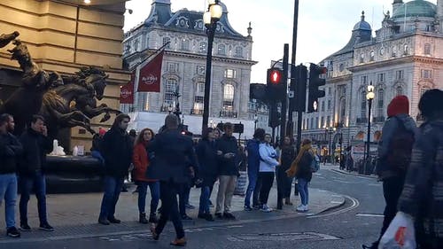 一群人站在人行道上等待过马路 · 免费素材视频