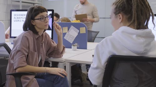 一个女人和她的同事谈论工作 · 免费素材视频