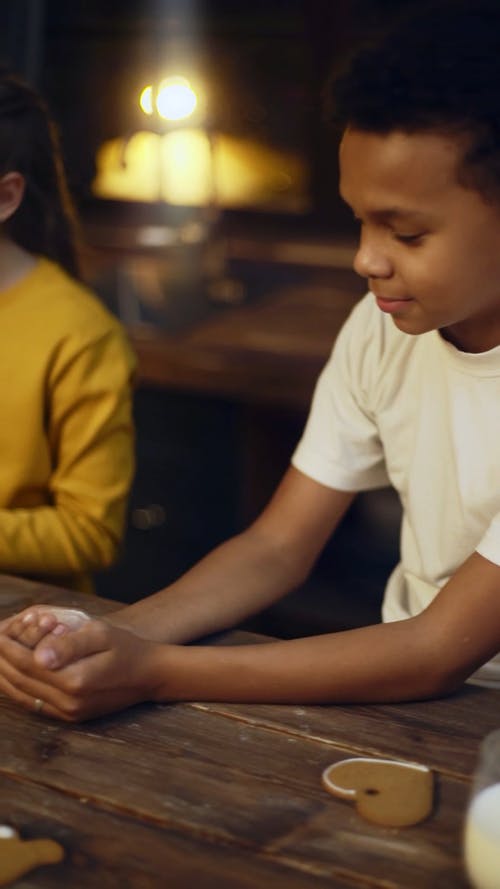 孩子们学习烘烤与男孩拍手在他手上的面粉 · 免费素材视频