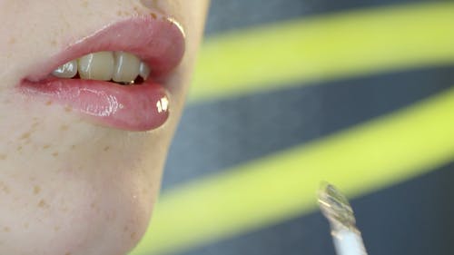 一个女人用唇彩涂抹器涂上唇彩 · 免费素材视频