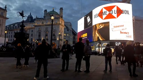 一群人站在广告牌前 · 免费素材视频