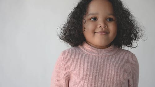 一个女孩穿着可爱的粉红色毛衣的特写视图 · 免费素材视频